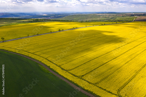 Aerial shot of fields with a tractor traces on the agricultural field sowing.