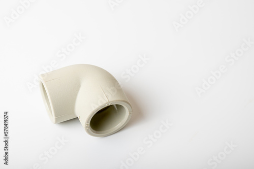 close-up, light PVC pipe tee, adapter connection for water isolated on light background © Jurii