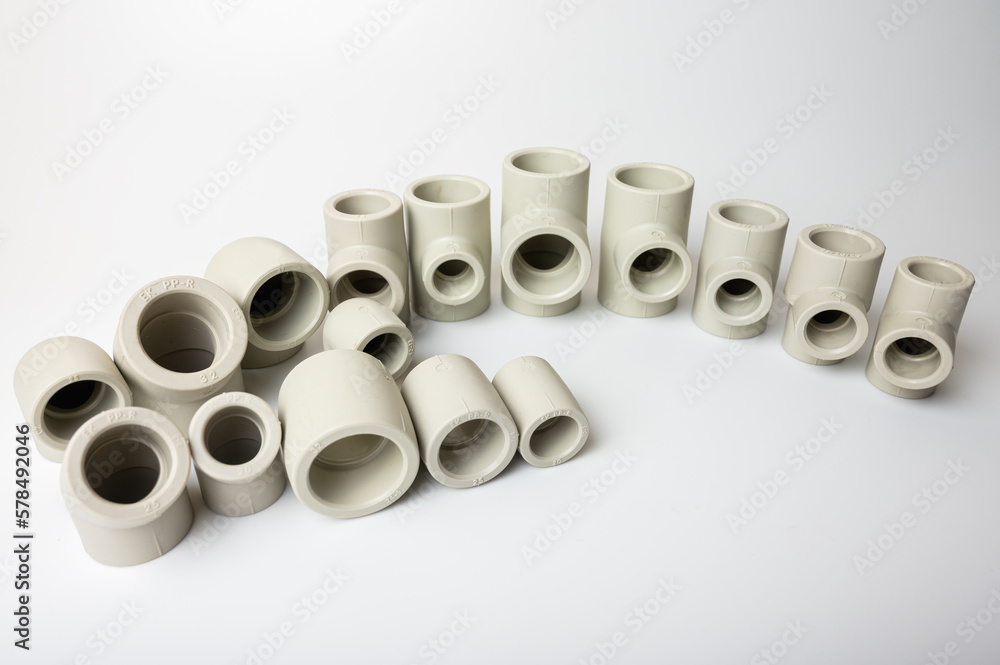 light gray PVC pipe tees for water, various types and diameters, isolated on a light background close-up. side view, top view