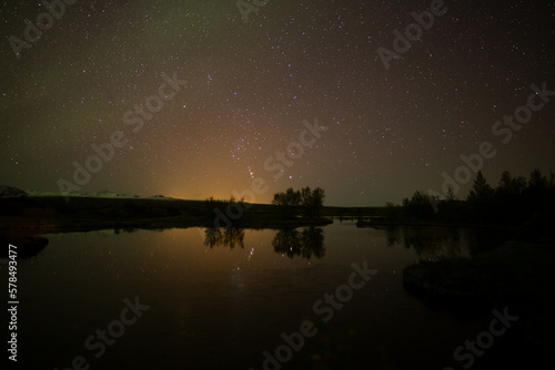 Mirror reflection of stars in calm water, Thingvellir Iceland