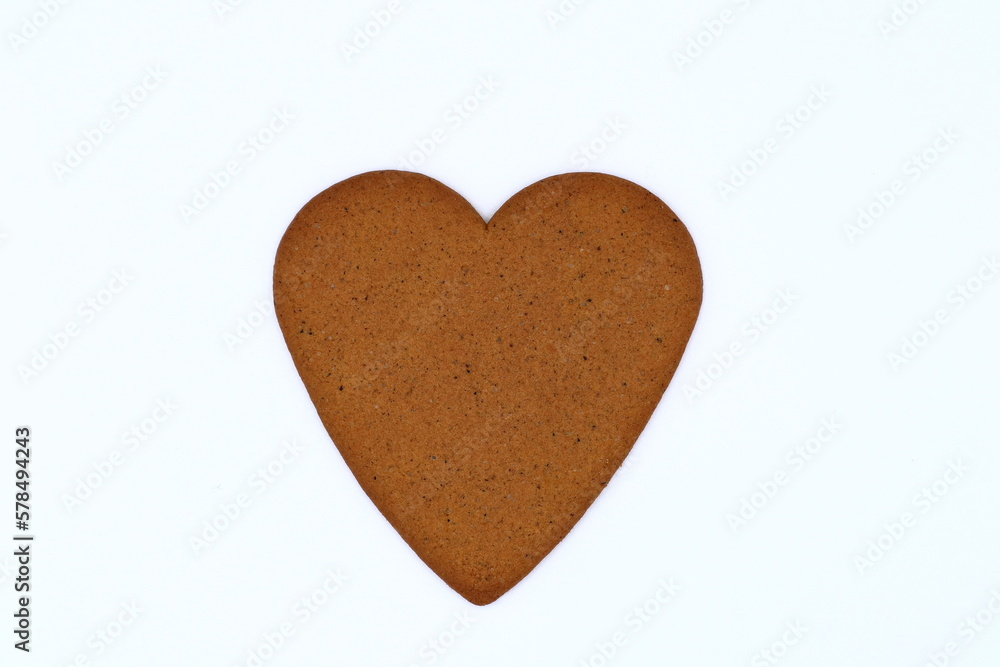 One heart shaped gingerbread cookie. Isolated on a white background. One heart shaped gingerbread cookie. Isolated on a white background.