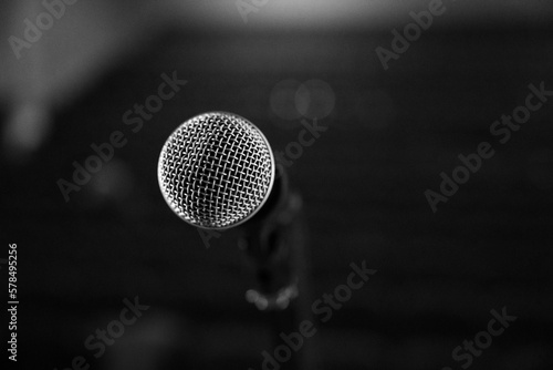 Microphone on stage on a blurry background from a close angle