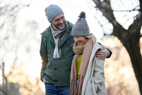 Embraced romantic couple enjoying a walk in the park