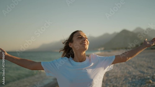 Summer sunny beach portrait of happy emotion woman with open arms and clothing eyes, enjoying fresh breezy air