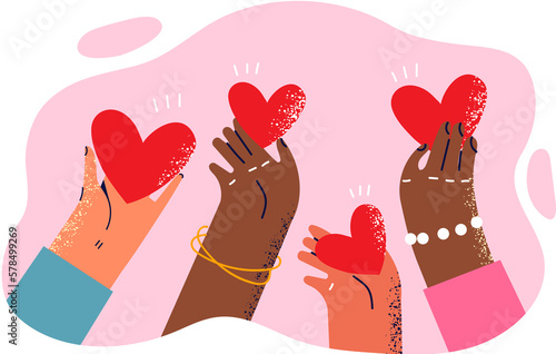 Hearts in hands of people different races symbolize kindness and charity towards ethnic minorities photo