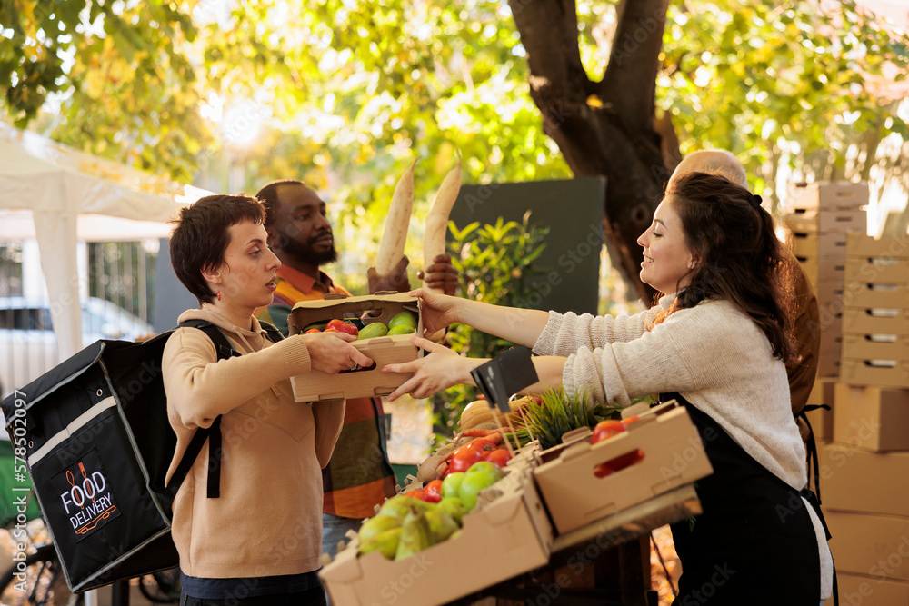 From farm to doorstep. Young girl courier wearing delivery bag picking