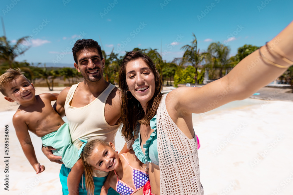 Happy biracial family taking selfie at beach Happy biracial family taking selfie at beach