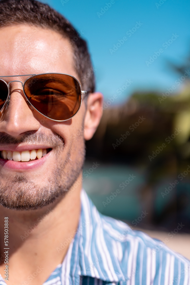 Portrait of happy caucasian man looking at camera and smiling at beach, with copy space Portrait of happy caucasian man looking at camera and smiling at beach, with copy space