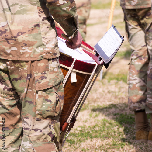 82nd Airborne Ceremonial Band on Stang Field, Fort Bragg, Fort Liberty, North Carolina. Close-up of Field Drummer, music, drum, and sticks. Full sun. photo