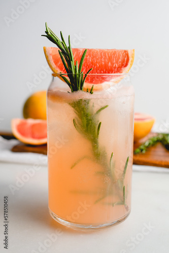 Honey Rosemary Grapefruit Soda Garnished with Red Grapefruit: Nonalcoholic soda served in can-shaped glasses with ice cubes