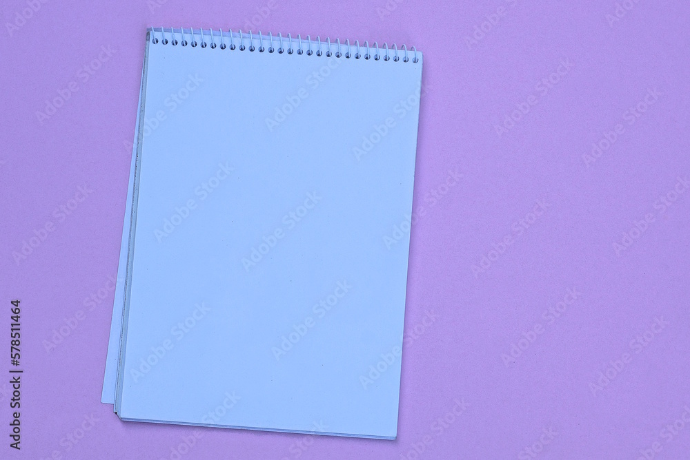 one white empty open notebook lies on a pink table one white empty open notebook lies on a pink table