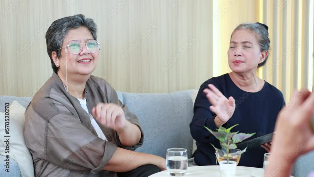 Elderly group of retired Asian male and female friends rs using tablet and have fun chatting with each other. Elderly group of retired Asian male and female friends rs using tablet and have fun chatting with each other.