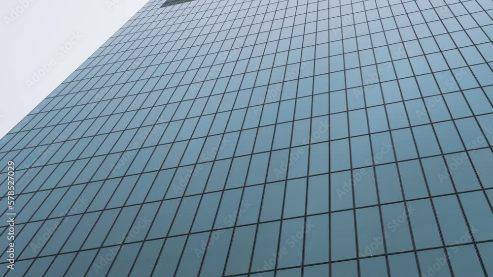 Modern glass office skyscraper building. 4K video with windows texture of this corporation headquarters building. Modern glass office skyscraper building. 4K video with windows texture of this corporation headquarters building.