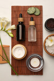 Flat lay composition with different spa products and flowers on white marble table