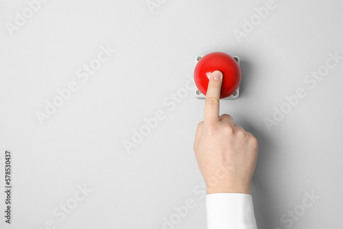 Obraz na plátne Man pressing red button of nuclear weapon on white background, top view with space for text