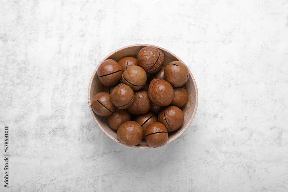 Obraz premium Delicious organic Macadamia nuts on light gray table, top view