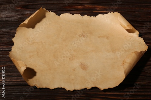 Sheet of old parchment paper on wooden table, above view