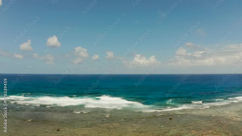 Big waves crashing on the coral reef and blue sky with clouds from above. Summer and travel vacation concept Big waves crashing on the coral reef and blue sky with clouds from above. Summer and travel vacation concept