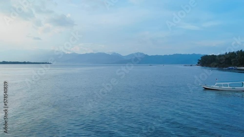 Wallpaper Mural Aerial shot flying over fishing boat before sunrise at dawn over calm waters in Bali, Indonesia. Blue mountains in the background. Beach holidays. Torontodigital.ca