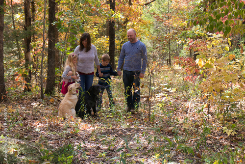 family walking in autumn forest