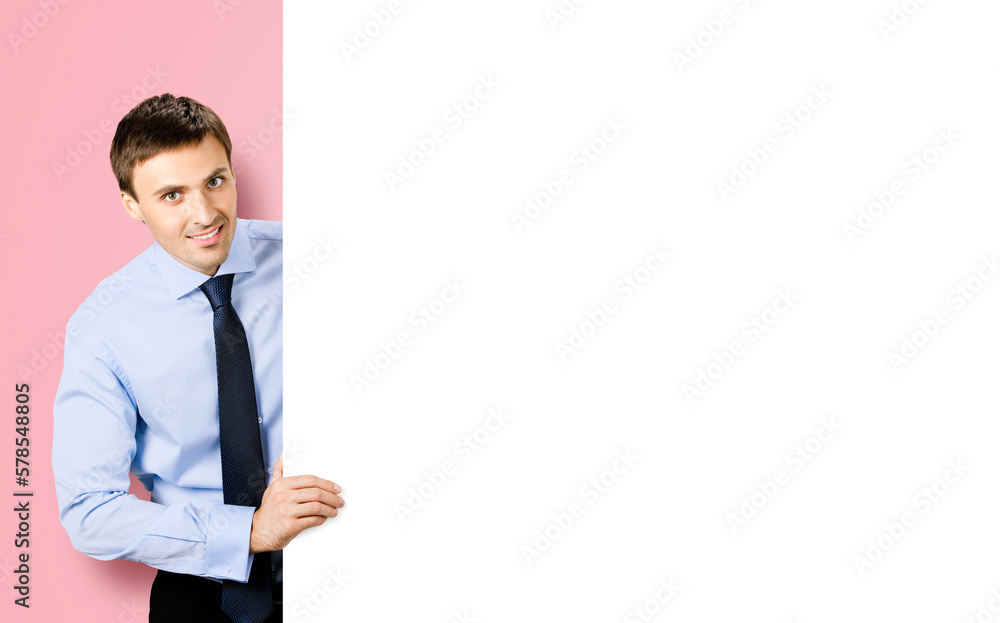 Portrait image of business man professional bank manager in confident cloth, necktie stand behind show empty white banner signboard billboard with copy space area. Isolated on rose pink background. Portrait image of business man professional bank manager in confident cloth, necktie stand behind show empty white banner signboard billboard with copy space area. Isolated on rose pink background.