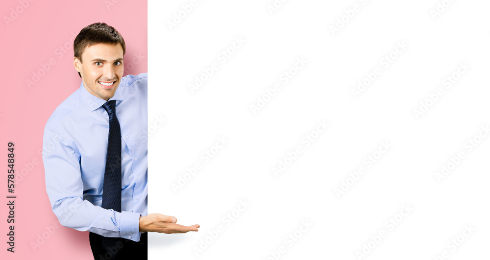 Portrait picture of young business man bank manager in confident cloth, necktie stand behind show empty white banner signboard billboard with copy space text area. Isolated on rose pink background Portrait picture of young business man bank manager in confident cloth, necktie stand behind show empty white banner signboard billboard with copy space text area. Isolated on rose pink background