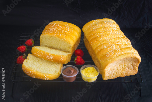 slice of bread with butter and chocolate jam on dark background 