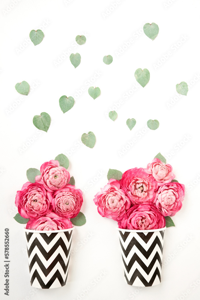 The concept of a flower shop and coffee shop. A coffee cup and flowers. Coffee to go. Petals of flowers, roses and ranunculus. Valentine's day romantic background . Space for text. The concept of a flower shop and coffee shop. A coffee cup and flowers. Coffee to go. Petals of flowers, roses and ranunculus. Valentine's day romantic background . Space for text.