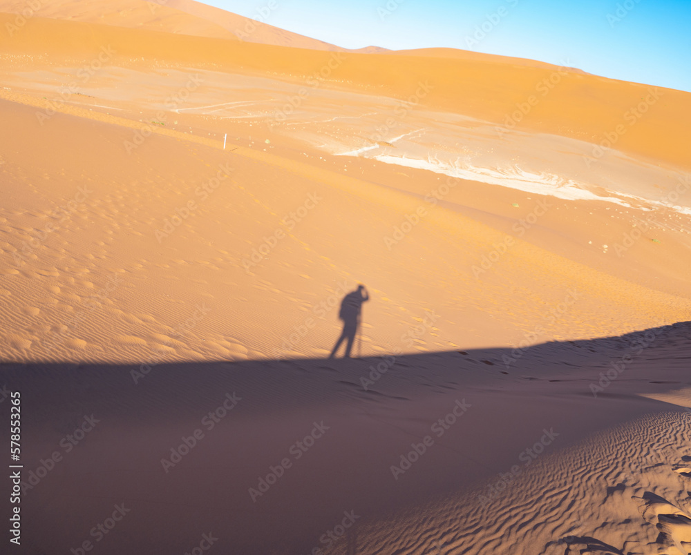 Tourist people on Desert Safari with sand dune in Namibia, South Africa. Natural landscape background at sunset time. Famous tourist attraction. Pattern texture of sand. Grand Canyon