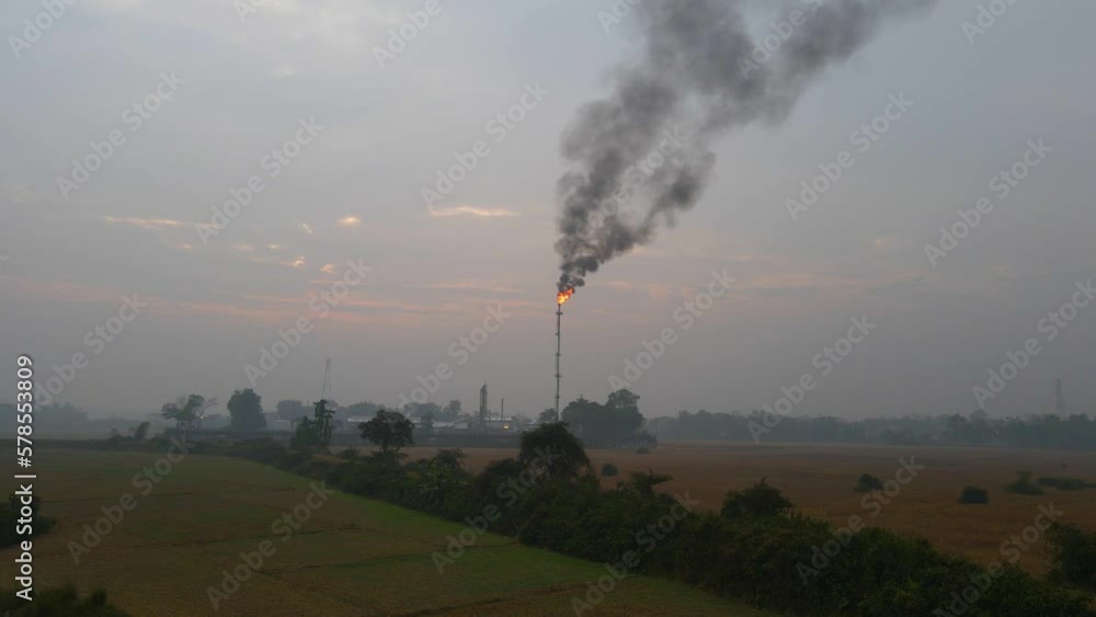 Thick black smoke constantly billowing out of the chimney at gas refinery Thick black smoke constantly billowing out of the chimney at gas refinery