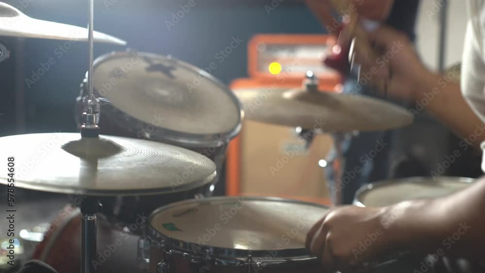 Person beating drums to rhythm at concert, close up view Person beating drums to rhythm at concert, close up view