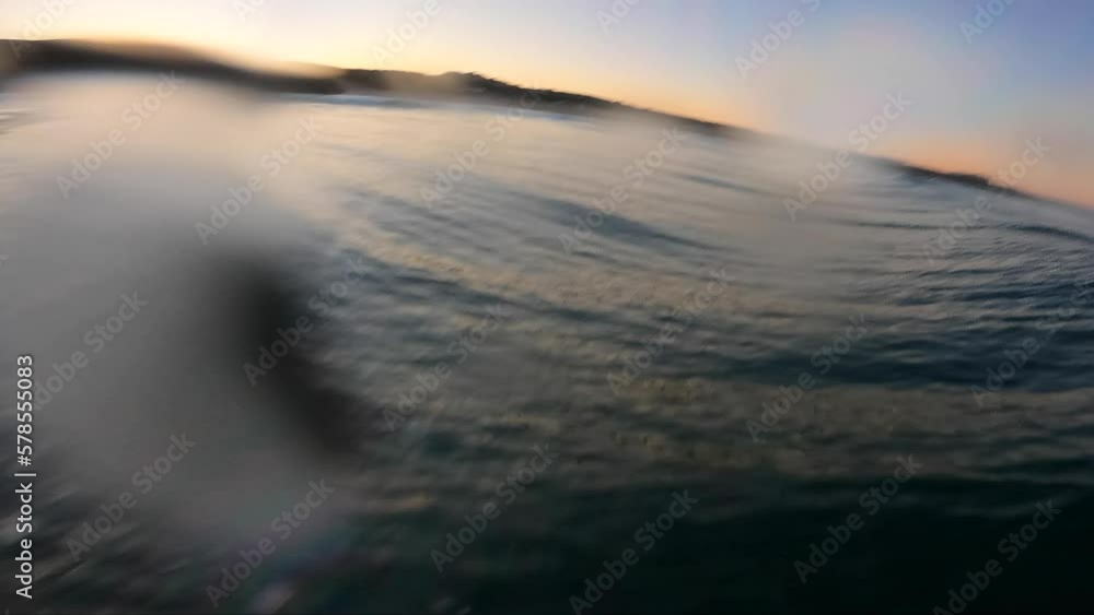 Surfer paddling and surfing a reef wave in ambient morning light on tropical surf spot. Surfer paddling and surfing a reef wave in ambient morning light on tropical surf spot.