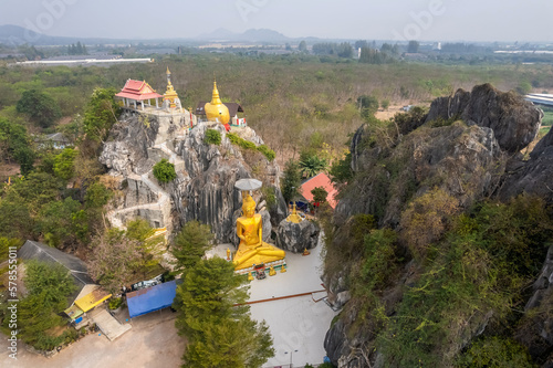 The big gold Buddha statue at Tham Champathong monastery, Ratchaburi, Thailand photo