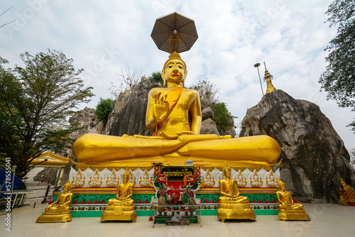 The big gold Buddha statue at Tham Champathong monastery, Ratchaburi, Thailand photo