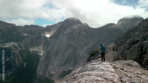 Wallpaper Mural Hiker preparing himself for a trail while the drone is surrounding him letting you see a remote valley with a big mountain on the background. Torontodigital.ca