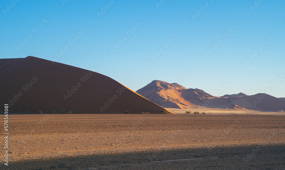 Namib Desert Safari with sand dune in Namibia, South Africa. Natural landscape background at sunset. Famous tourist attraction. Sand in Grand Canyon Namib Desert Safari with sand dune in Namibia, South Africa. Natural landscape background at sunset. Famous tourist attraction. Sand in Grand Canyon