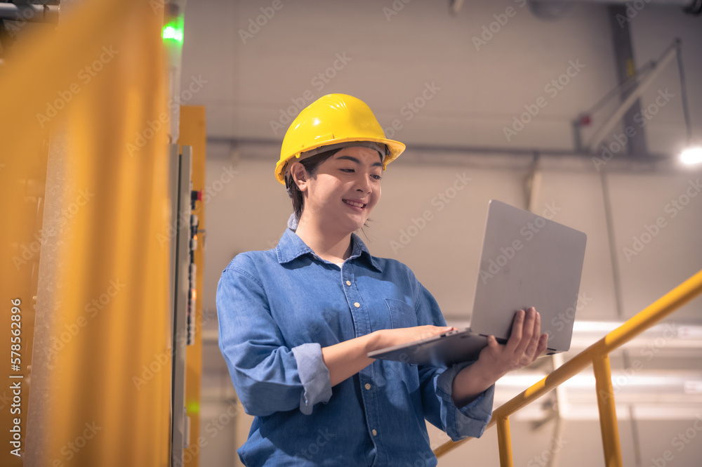 Asian woman Engineer using computer working in factory Asian woman Engineer using computer working in factory