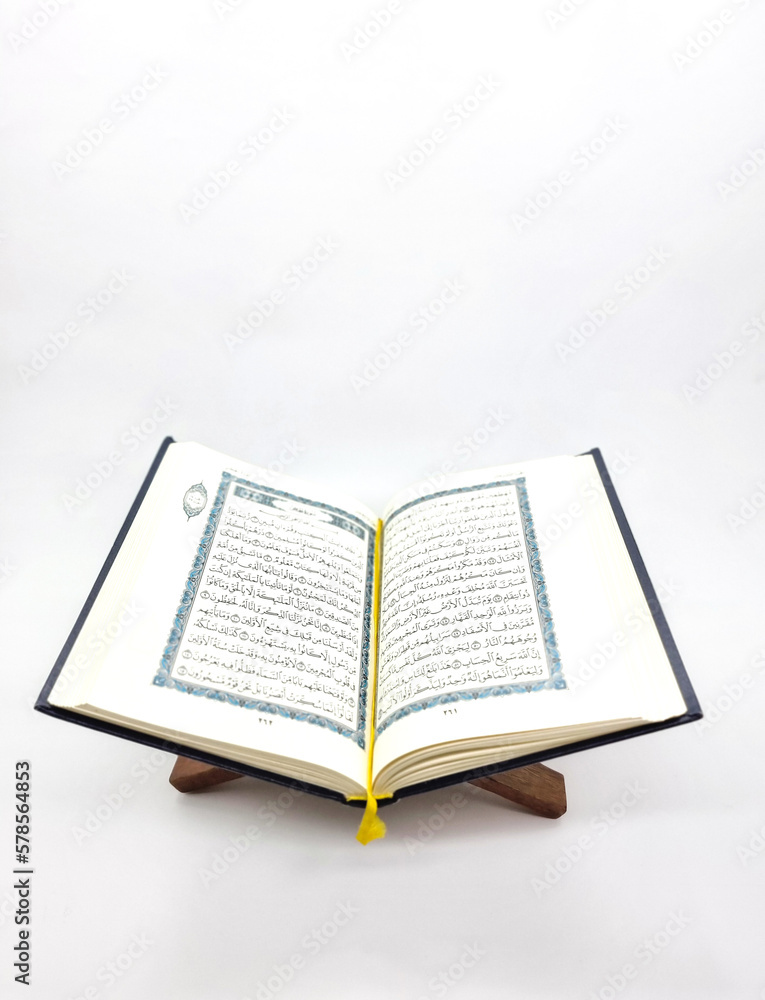 Ramadan Kareem, Eid Mubarak or Islamic concept. The Islamic holy book, Quran or Kuran, on grey background. Arabic words on the book means Ramadan Kareem, Eid Mubarak or Islamic concept. The Islamic holy book, Quran or Kuran, on grey background. Arabic words on the book means