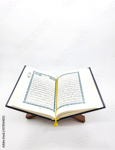 Ramadan Kareem, Eid Mubarak or Islamic concept. The Islamic holy book, Quran or Kuran, on grey background. Arabic words on the book means 