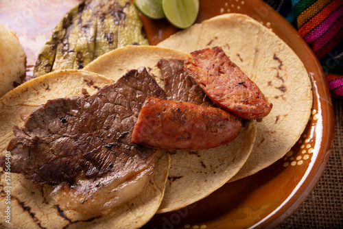 Carne Asada. (roast meat) very popular dish in northern Mexico, also called Asado, Discada or Parrillada, is a cooking technique in which food is exposed to the heat of the embers. photo