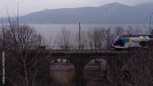 The passenger train passes on the railway near lake Maggiore (2) photo