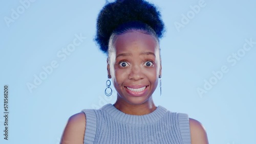 Guilt, embarrassed and awkward with a black woman in studio on a blue background feeling nervous. Thinking, idea and worried with a young feeling looking insecure or anxious about a mistake photo