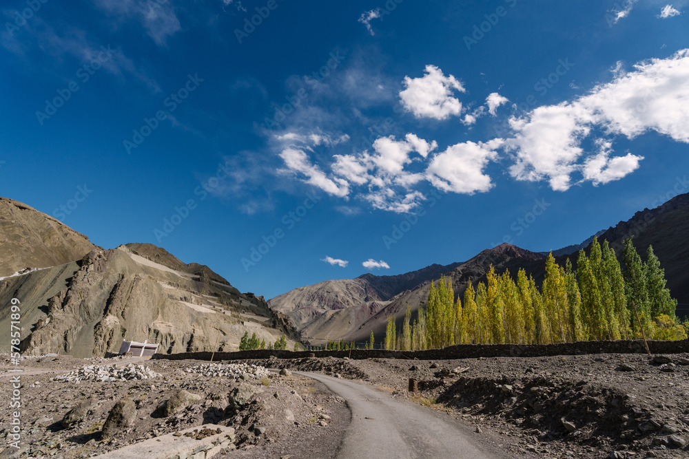 Beautiful landscape with long road and mountain blue sky background view near Ladakh, north India.
