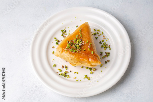 Traditional Turkish desserts; custard triangular dessert, albanian dessert ( Turkish name; Arnavut tatlisi or muhallebili muska tatlisi) photo