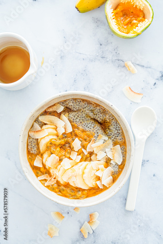 Chia pudding with passion fruit, coconut and coconut yogurt in bowl. Healthy vegan recipe.