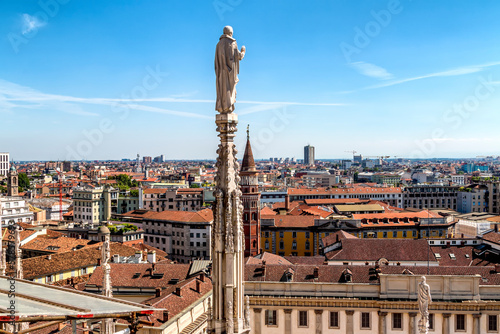Statues atop the spires of the Duomo di Milano, the Milan cathedra  in the crown of spires each topped by a unique statue intricate stone sculptures, spires, gargoyles and statues is most recognizable © Asim