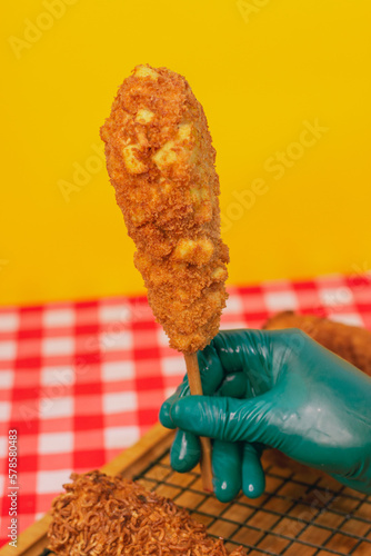 corn dogs in yellow background 