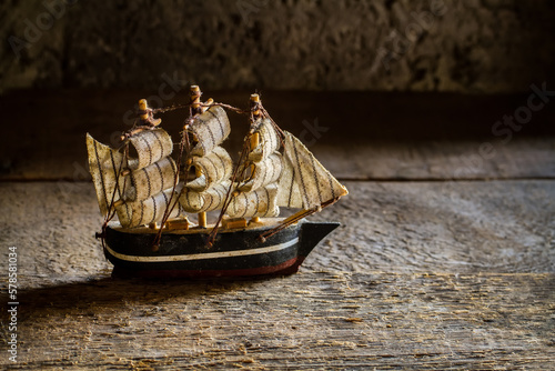 Wooden model of a sailboat. Old dusty homemade ship model.