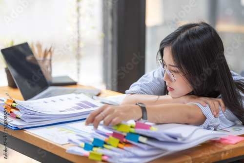 Asian women are stressed while working on laptop, Tired asian businesswoman with headache at office, feeling sick at work, copy space 