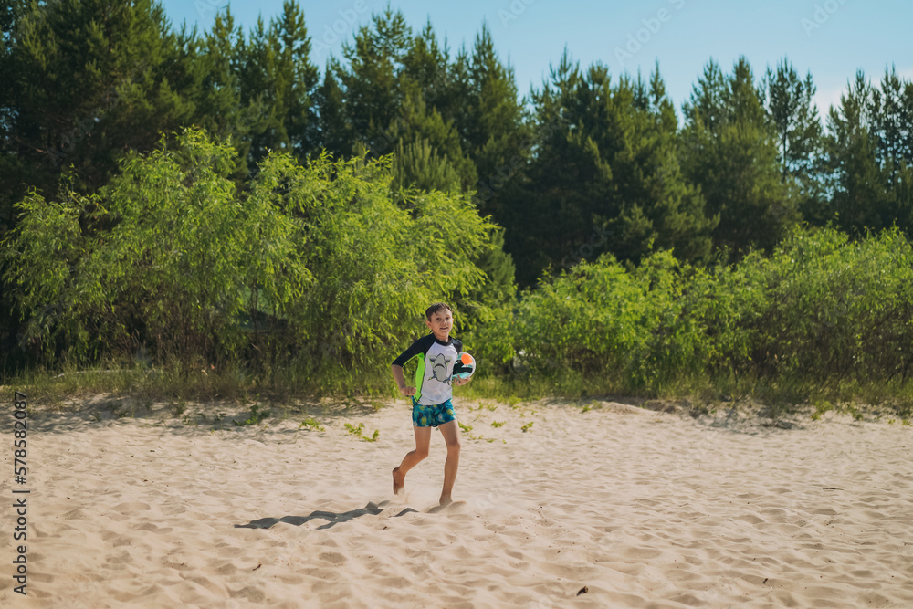 cute caucasian boy holding snorkel mask running into water with laughter. Vacation on sea side. Happy childhood. Image with selective focus. cute caucasian boy holding snorkel mask running into water with laughter. Vacation on sea side. Happy childhood. Image with selective focus.